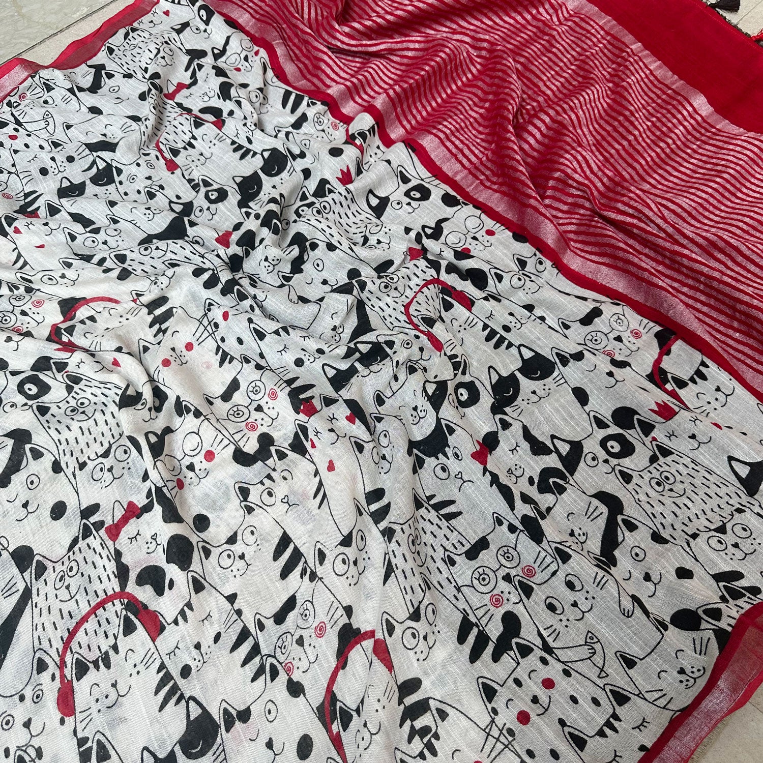 The Great Catsby ivory cotton saree closeup with black illustrated cat crowd print and crimson red zari pallu, Zoomies Collection Thread Weavers