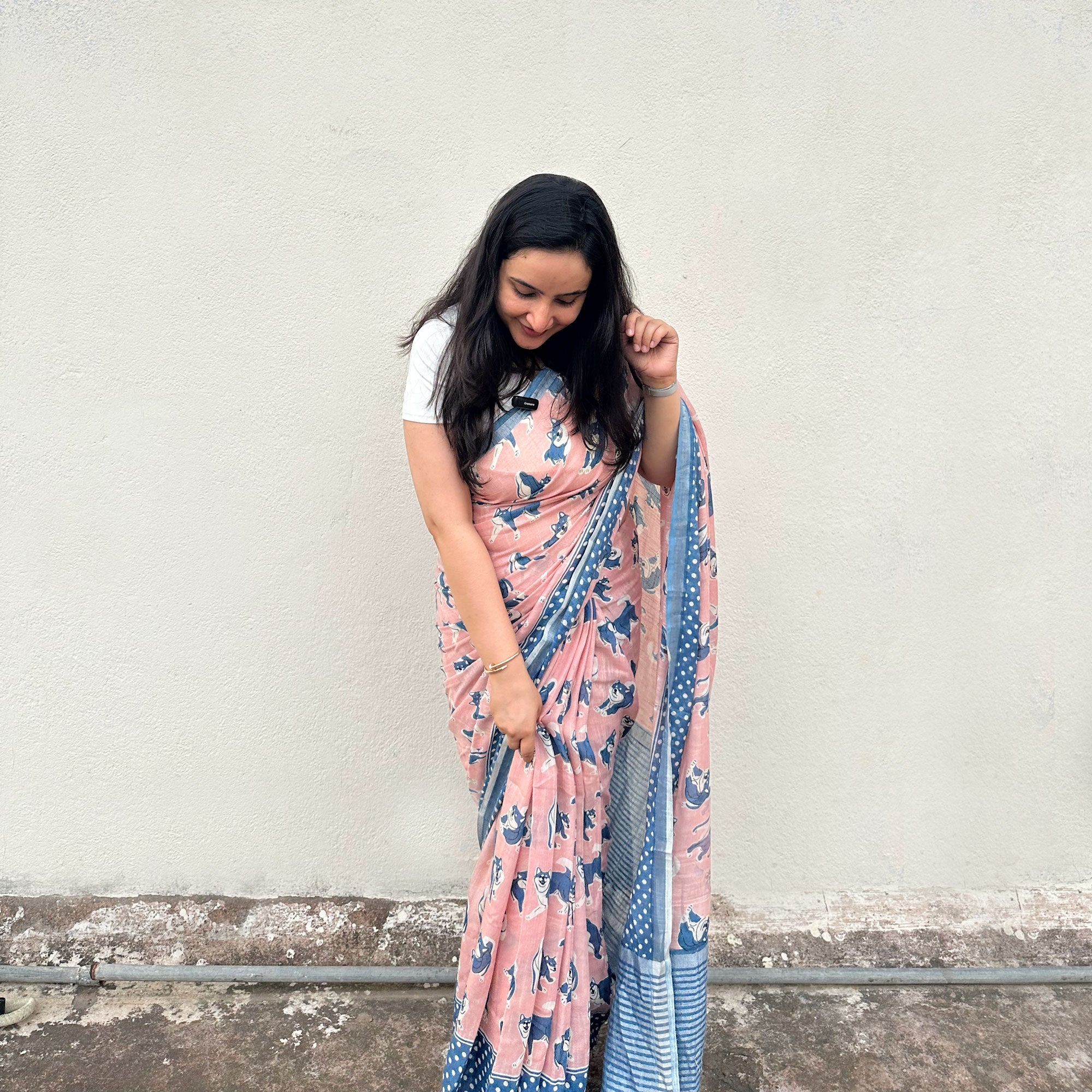 Founder wearing the Pawdcast blush pink cotton Shiba Inu dog print saree with polka dot border and steel blue zari pallu, Zoomies Collection TTW