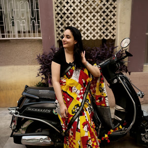 Founder wearing Who Let The Dogs Dress Up yellow red patchwork dog print saree with illustrated dog panels and black zari pallu, Zoomies Collection TTW