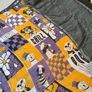 Woof There It Is purple mustard patchwork dog print cotton saree closeup with Dog Mom typography and black zari pallu, Zoomies Collection Thread Weavers