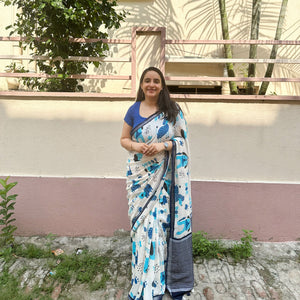 Founder wearing Woof & Wonder ivory cotton saree with blue illustrated dog and WOOF typography print and navy zari pallu paired with Navy Blue Blouse, Zoomies Collection TTW