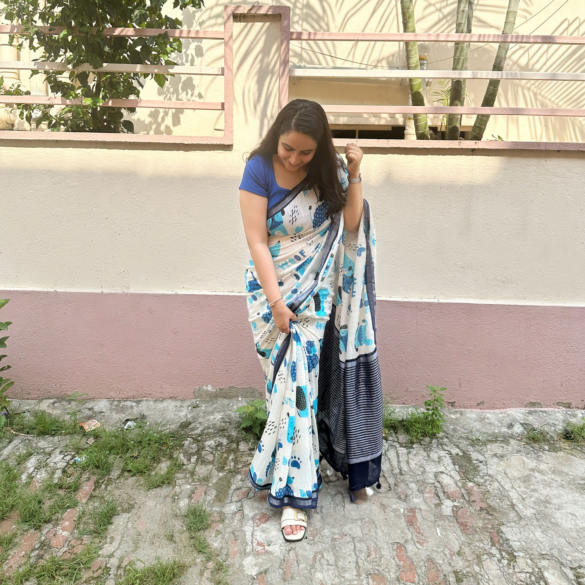 Founder wearing Woof & Wonder ivory cotton saree with blue illustrated dog and WOOF typography print and navy zari pallu paired with Navy Blue Blouse, Zoomies Collection TTW