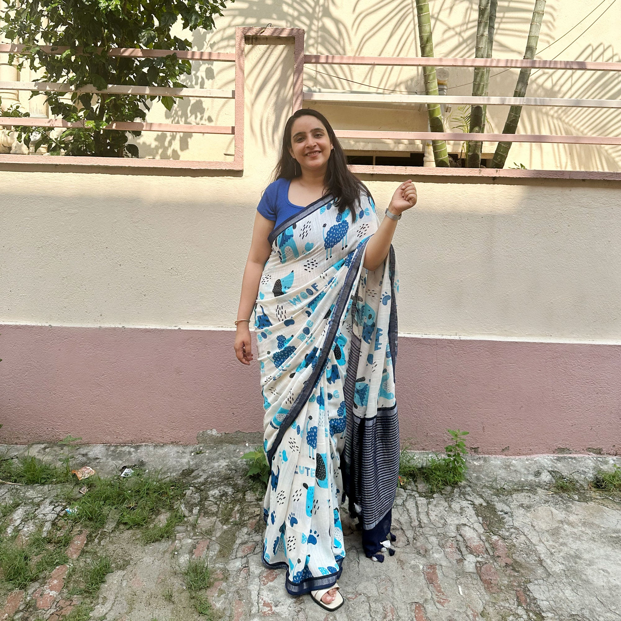Founder wearing Woof & Wonder ivory cotton saree with blue illustrated dog and WOOF typography print and navy zari pallu paired with Navy Blue Blouse, Zoomies Collection TTW