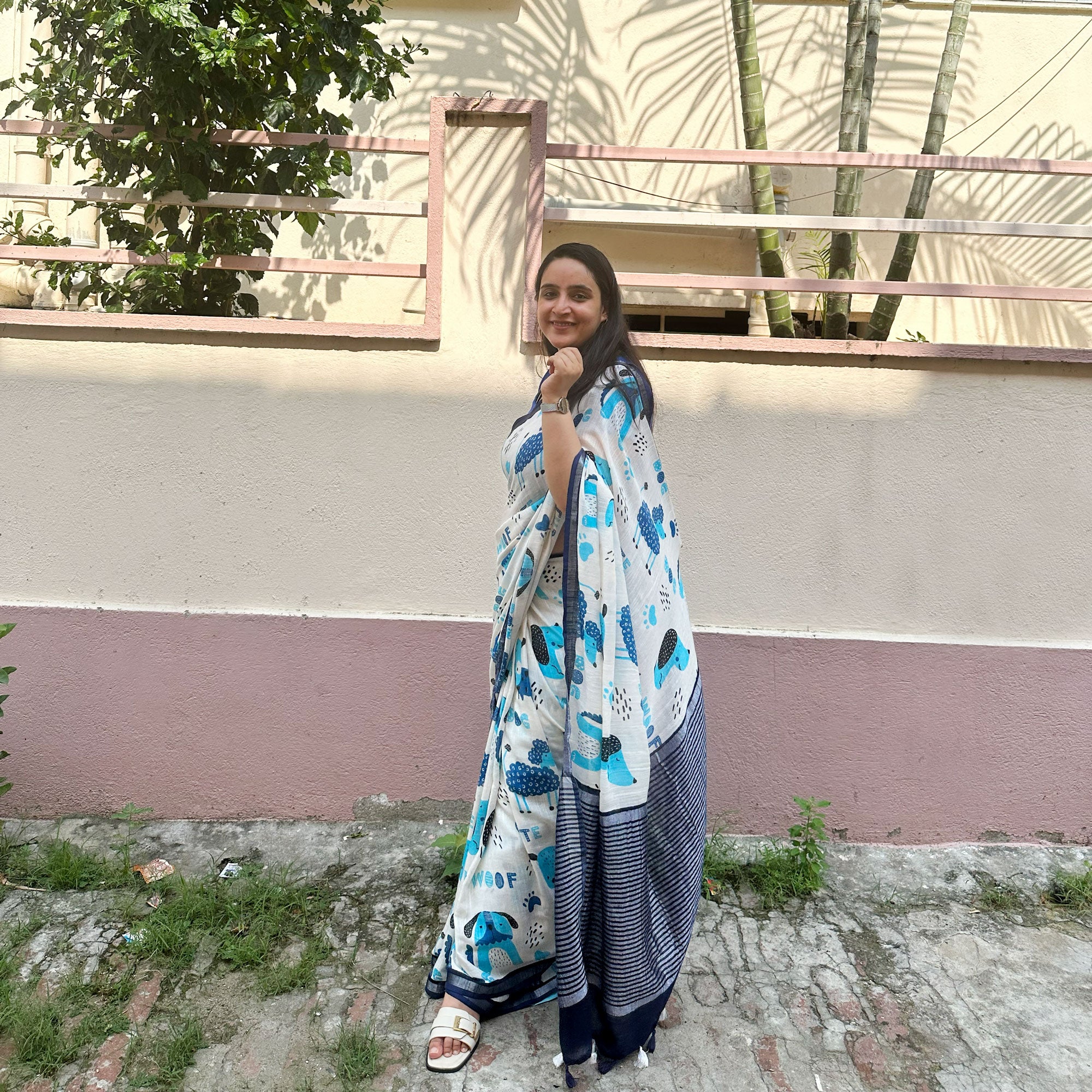 Founder wearing Woof & Wonder ivory cotton saree with blue illustrated dog and WOOF typography print and navy zari pallu paired with Navy Blue Blouse, Zoomies Collection TTW